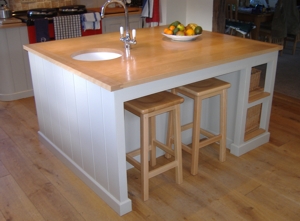 A picture of a painted kitchen island, with polished beech top